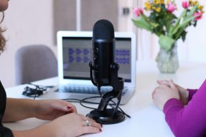 two people recording a podcast