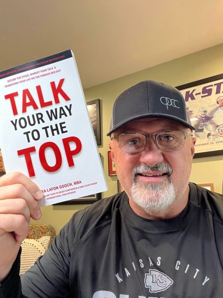 Todd holding up a copy of Tara's book