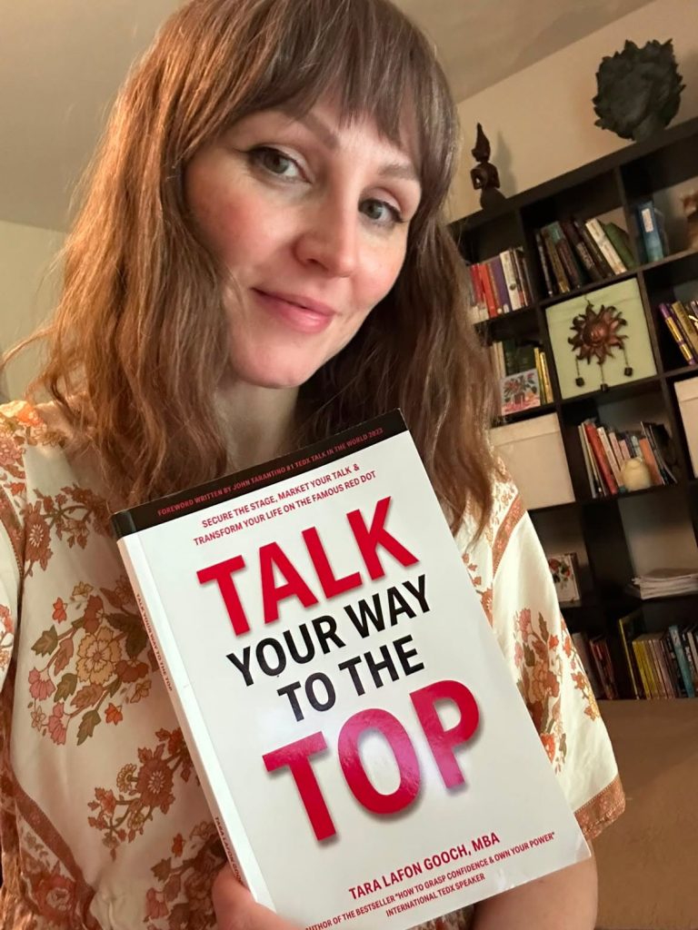 Ramona a fan of Tara's on Instagram is holding up a copy of her book
