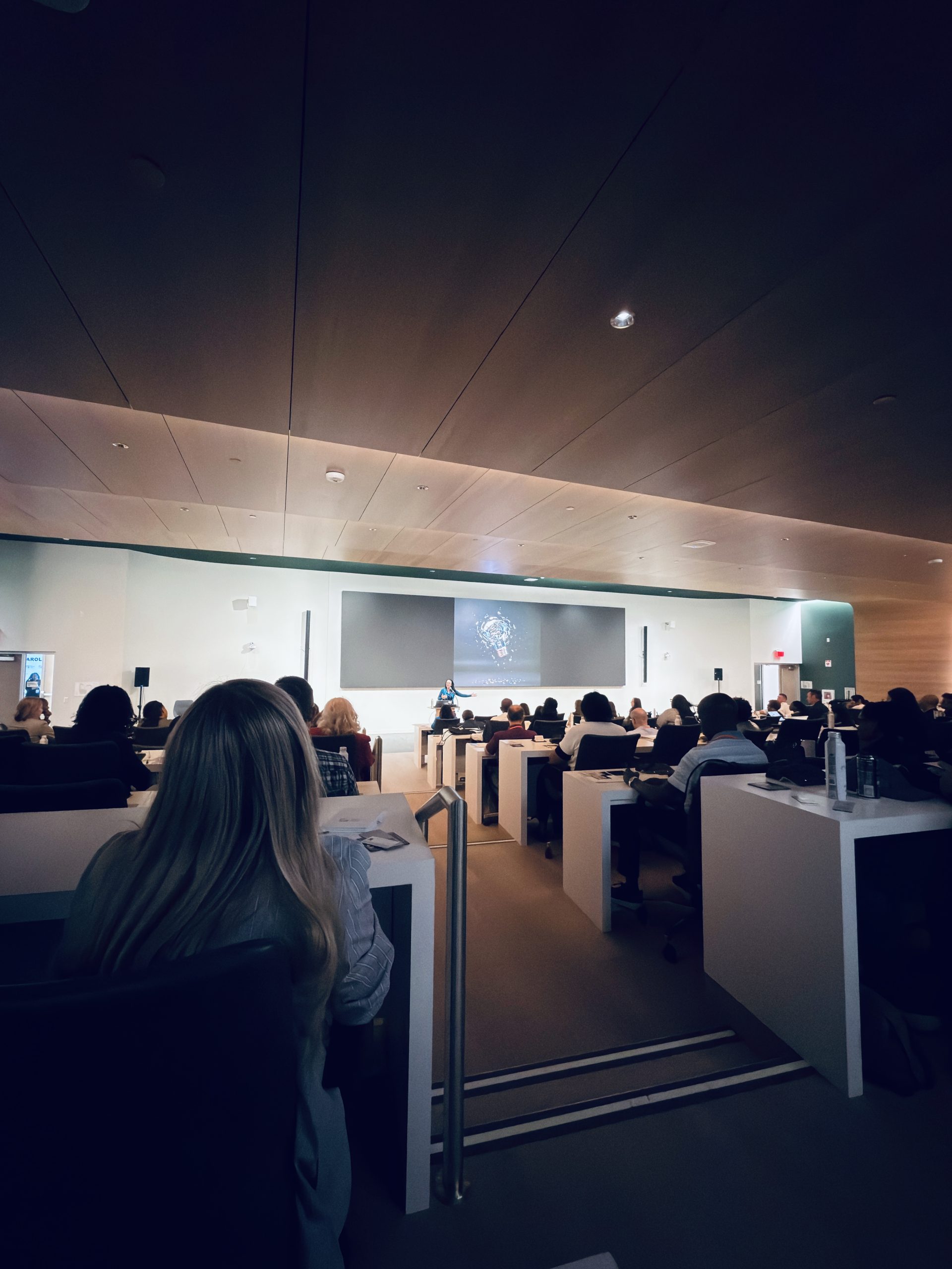 Tara delivering a corporate keynote in a training center