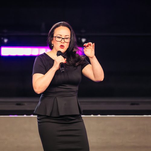 Tara LaFon Gooch on stage delivering a speech on Christian faith