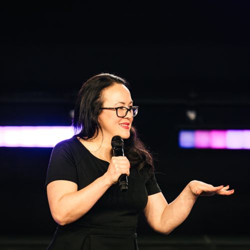 Tara LaFon Gooch on stage delivering a speech on Christian faith