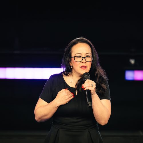 Tara LaFon Gooch on stage delivering a speech on Christian faith