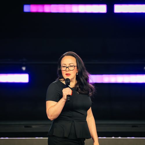 Tara LaFon Gooch on stage delivering a speech on Christian faith