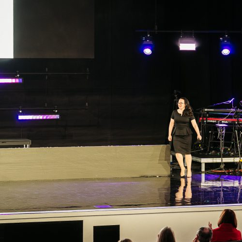 Tara LaFon Gooch on stage delivering a speech on Christian faith